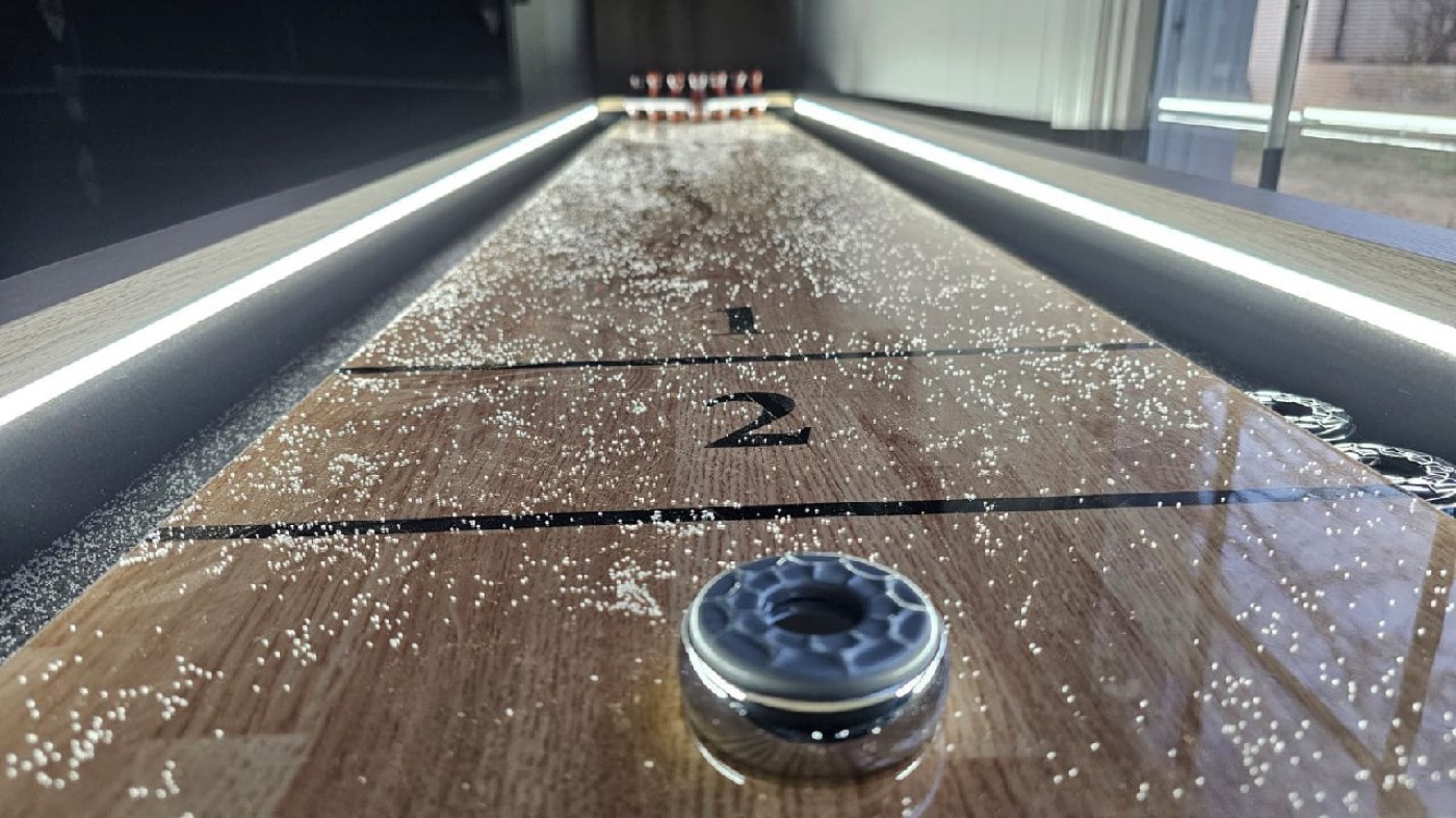 Shuffleboard table with LED lighting at Mojo's Arcade